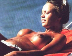 6. Anna Falchi – Topless sunbathing