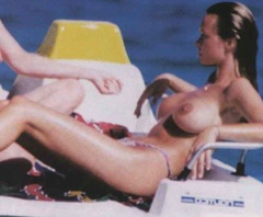 7. Anna Falchi – Topless sunbathing