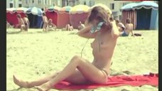 10. Dalila Di Lazzaro Shows Boobs on Beach – Trois Hommes A Abattre