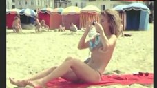 8. Dalila Di Lazzaro Shows Boobs on Beach – Trois Hommes A Abattre