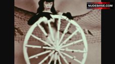 7. Bettie Page Posing Naked with Wheel – The Exotic Dances Of Bettie Page