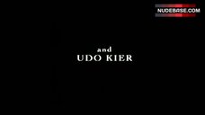 23. Antoinette Valente Sitting Nude on Table – Red Letters